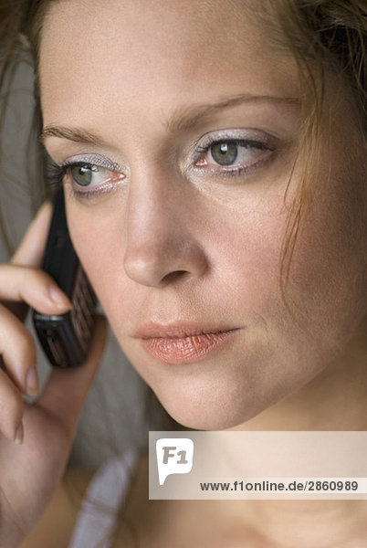 Young woman using mobile phone  close up
