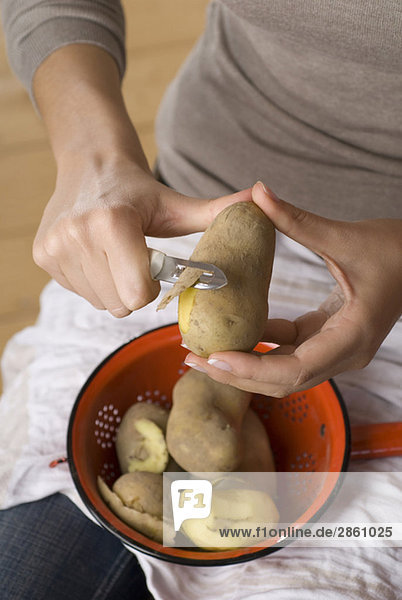 Person peeling potatoes  elevated view