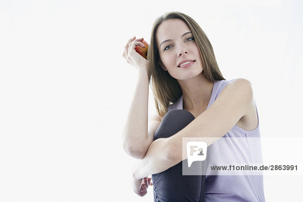 Young woman holding apple  portrait