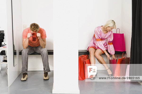 Couple sitting in fitting room