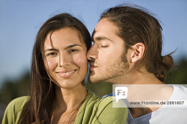 Man kissing a woman