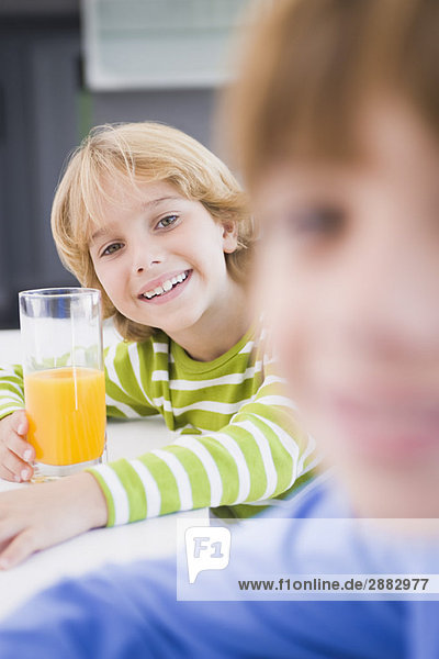 Boy holding a glass of juice