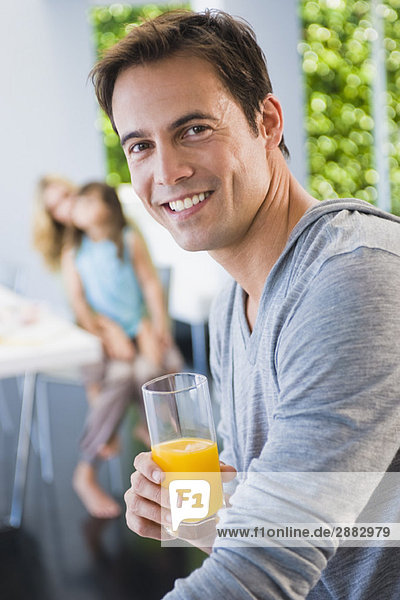 Man holding a glass of juice