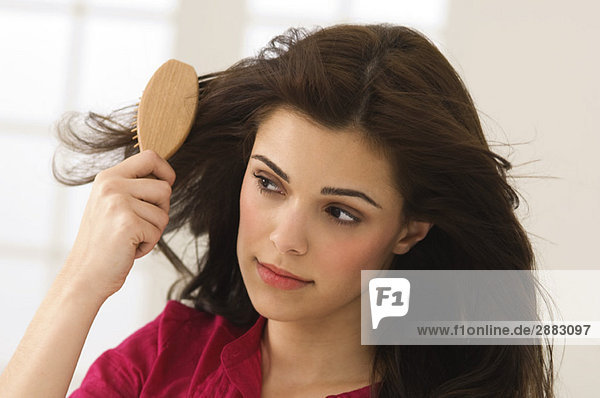 Close-up of a woman brushing her hair
