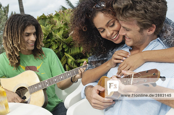 Woman embracing a man playing ukulele