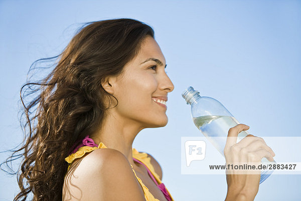 Woman holding a water bottle and smiling