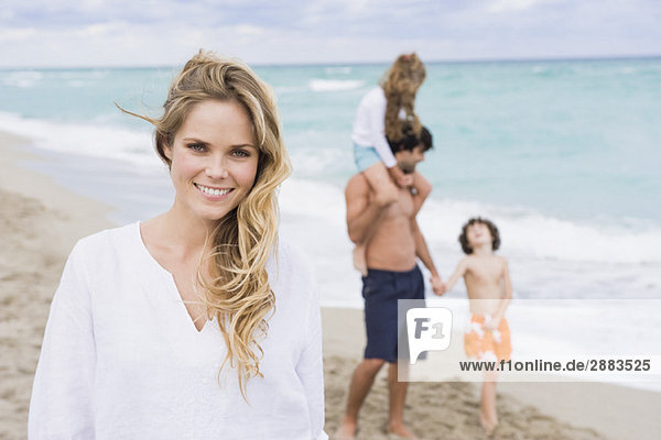 Woman smiling with her family in the background