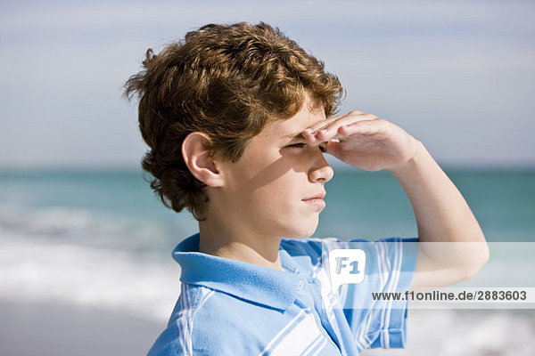 Close-up of a boy looking out to sea