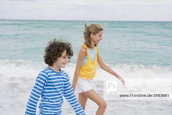 Boy walking with a girl on the beach