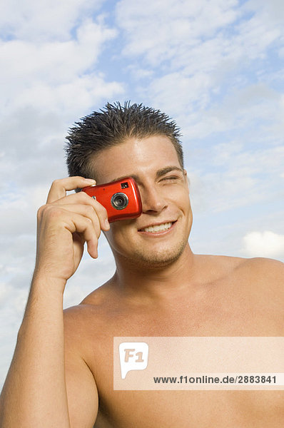 Man taking a picture with a digital camera