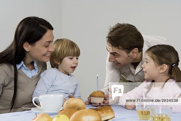 A family celebrating a the birthday of their son
