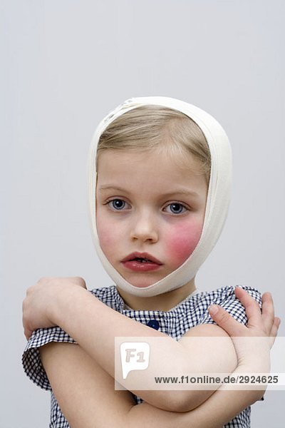 A young girl with a head injury and cheek injury