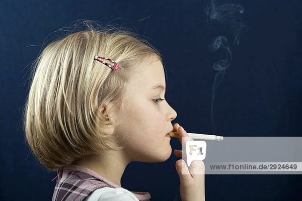 A young girl smoking a cigarette