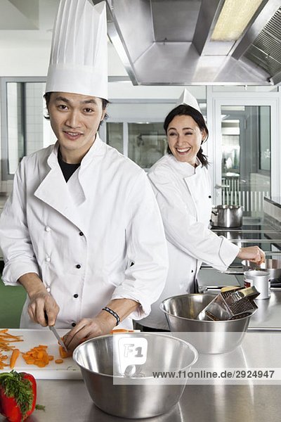 Two chefs having fun while working