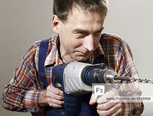 A man using a large drill