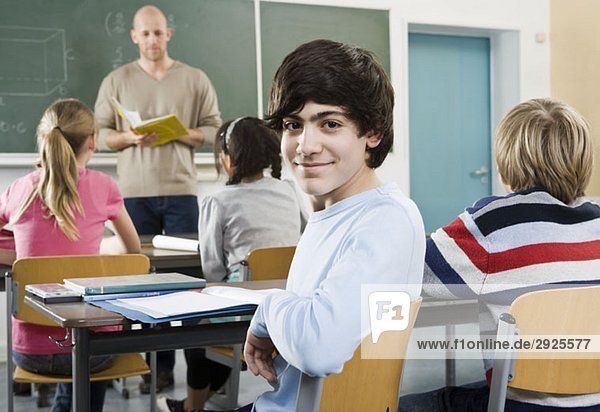 Portrait of a boy sitting in a classroom
