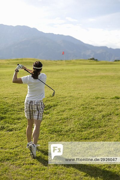 A woman playing golf  Palm Springs  California  USA