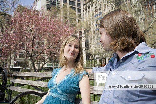 Ein junges Paar sitzt zusammen auf einer Parkbank  Central Park  New York City