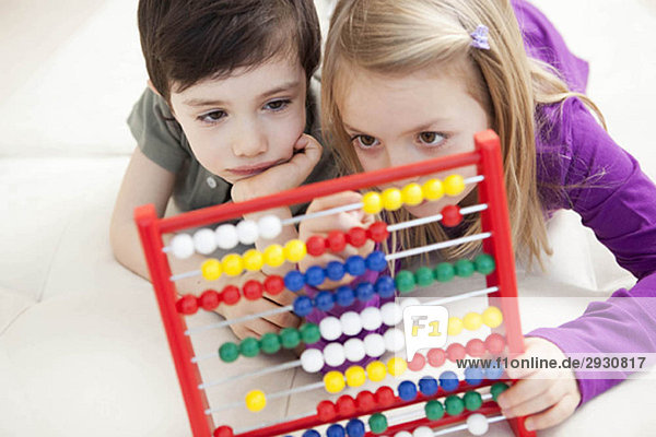 brother and sister playing with abacus