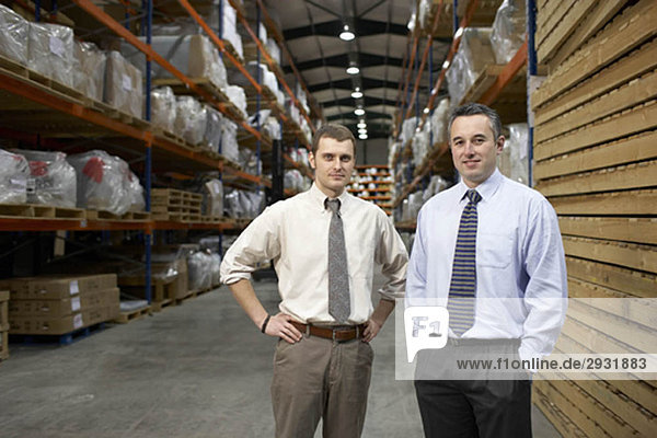 Two businessmen in warehouse  portrait