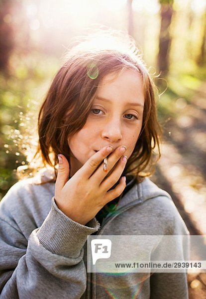 A girl pretending to smoke Sweden.