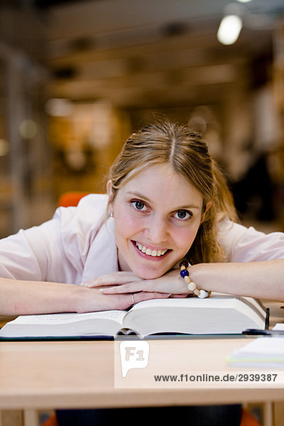 A female student studying in a library Sweden.