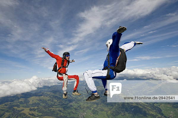 two people doing parachute jumping  full shot
