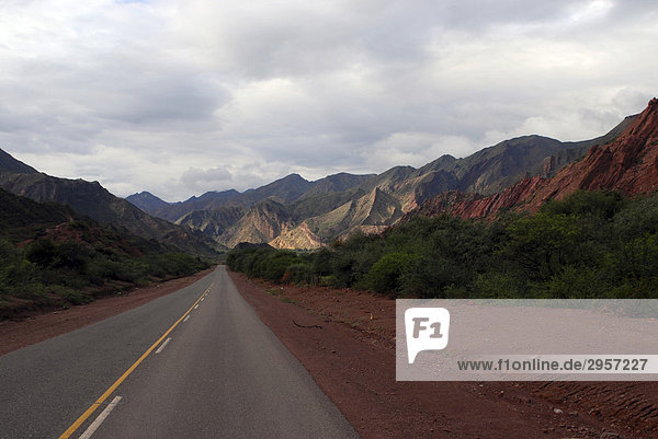 Straße mit Panoramablick auf bunte Sandsteinformationen  Quebrada del RÌo Las Conchas  Cafayate  Provinz Salta  Anden  Argentinien  Südamerika