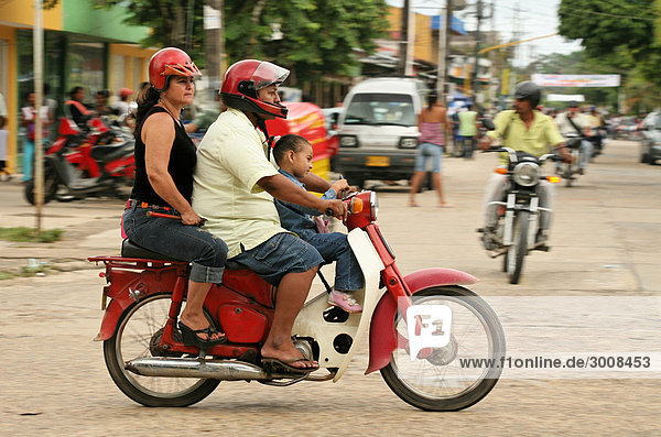 10857655  Leticia city  Colombia  street  scence  road  local people  locals  natives  motorcycle  motorbike  bike  driving  houses  traffic  family  child  life  tropics  tropical