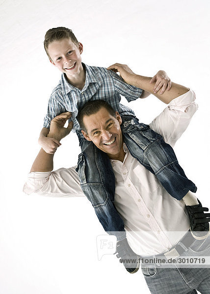 Father carrying son on his shoulders  diagonal  studio shot