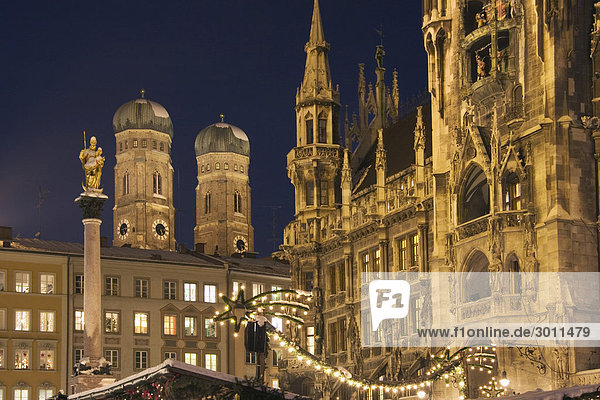 Christmas market on Marien-Place Munich with Marien-clumn townhall and cathedral Bavaria Germany