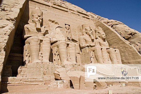 Headline: Colossal statues at the Temple of Ramesses II in Abu Simbel  Egypt  low angle view