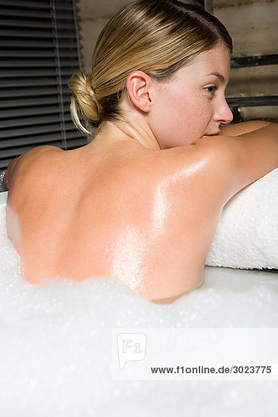 Young woman in bubble bath