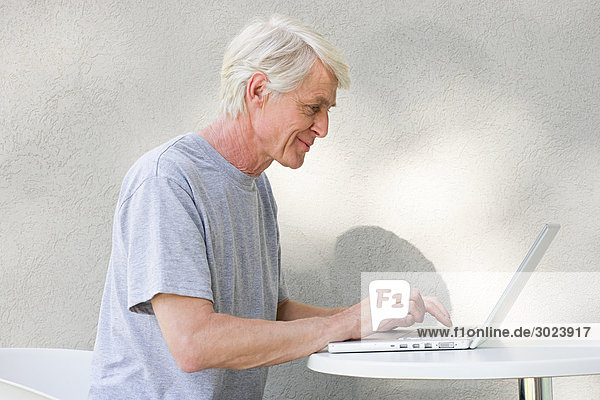 Middle aged man using laptop
