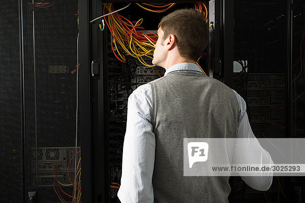 Male computer technician working on a server