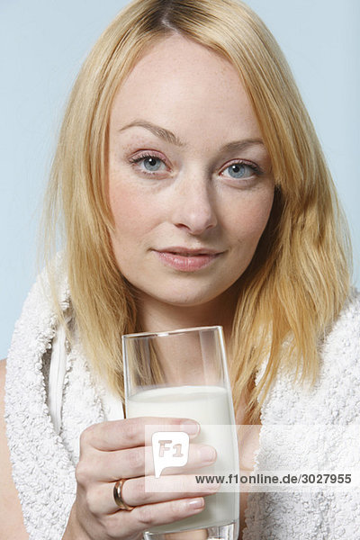 Young woman drinking glass of milk  portrait