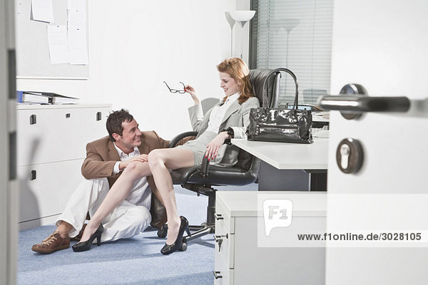 Germany  Business people in office  Business man touching woman's knee