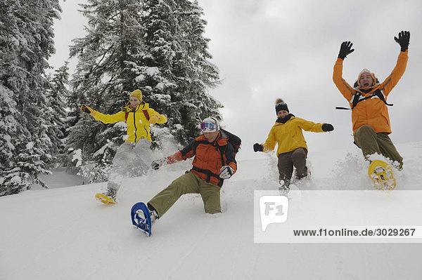 Italy  South Tyrol  People with snowshoes fooling about