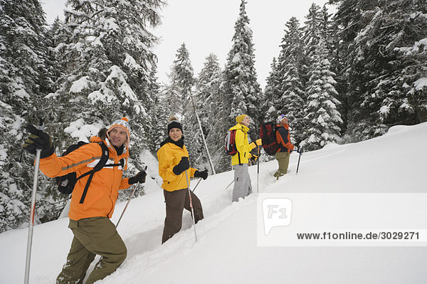 Italy  South Tyrol  People snowshoeing uphill