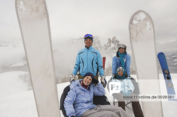 Italien  Südtirol  Vier Personen in Winterkleidung  die eine Pause einlegen