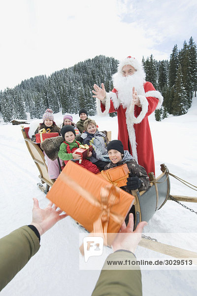 Italy  South Tyrol  Seiseralm  Santa Claus and children  children holding gift parcels