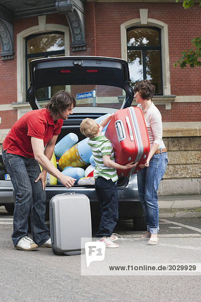 Germany  Leipzig  Family loading luggage into car