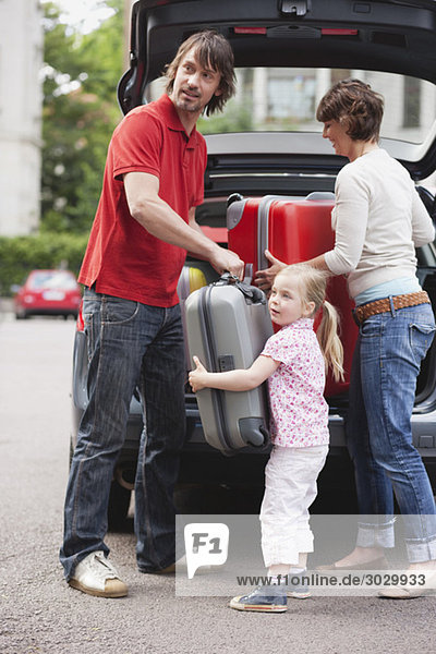 Germany  Leipzig  Family loading luggage into car