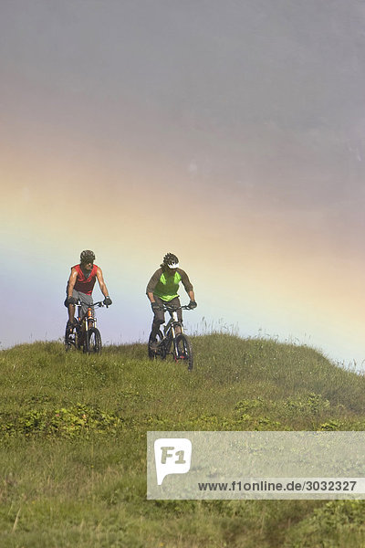 Iceland Two Men mountain biking in hilly landscape