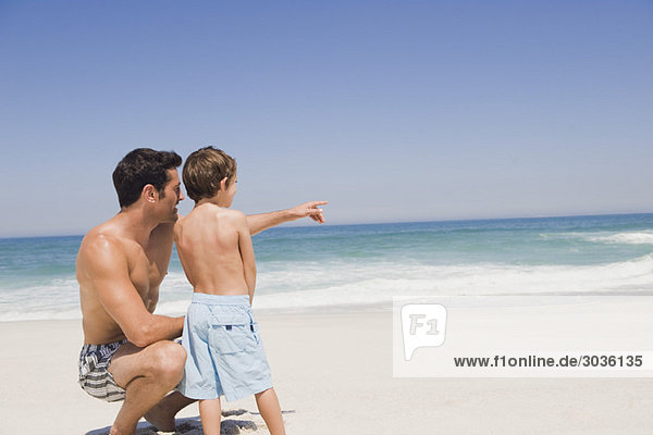 Ein Mann mit seinem Sohn am Strand.