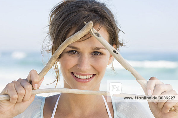 Woman making triangle shape with sticks