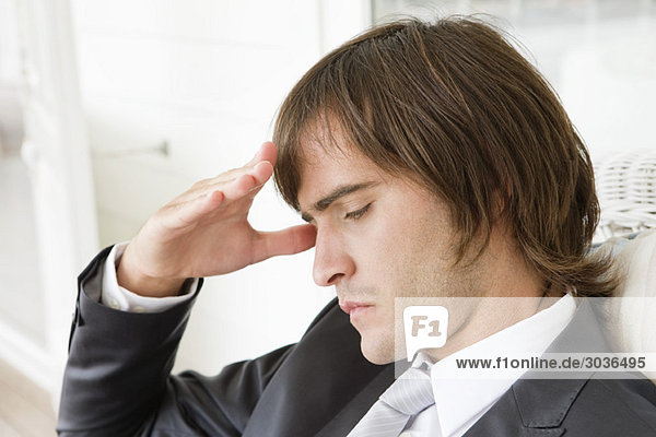 Close-up of a man suffering from a headache