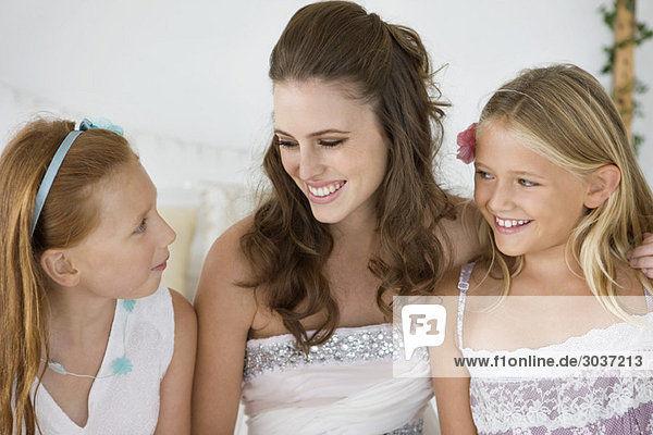 Braut sitzend mit zwei Mädchen