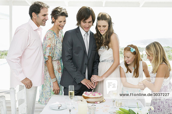 Newlywed couple with guests in a wedding party