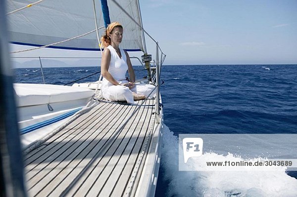Woman doing yoga on Sailing Boat